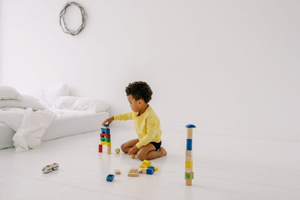 A toddler playing with first building blocks