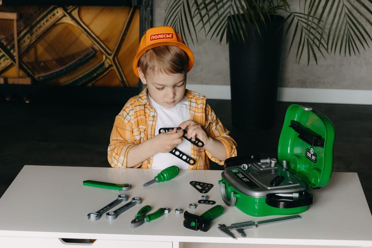 A child concentrating deeply on a construction toy