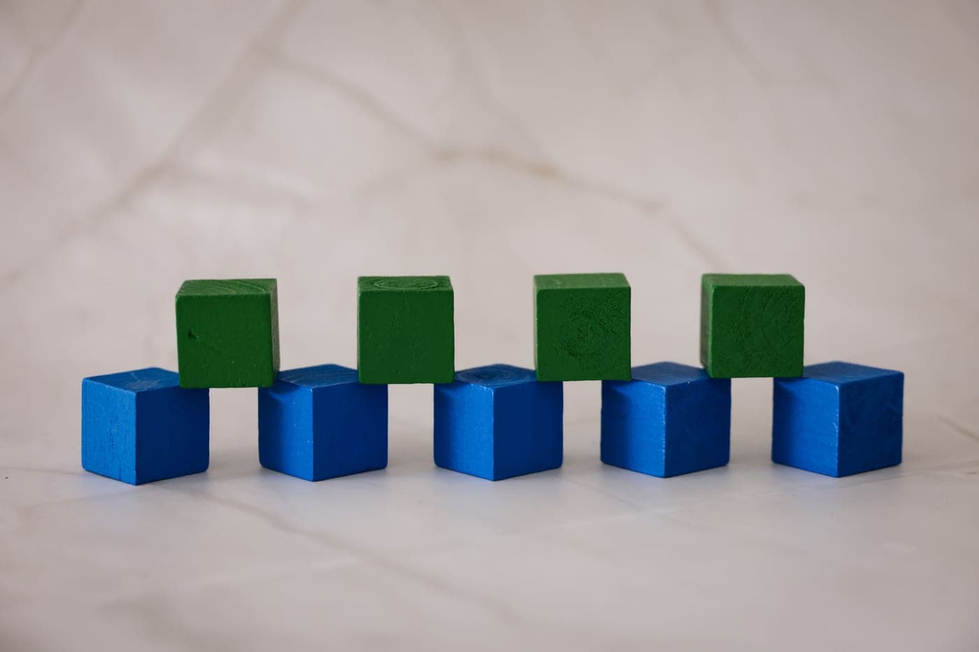 Wooden toy blocks arranged on a white surface